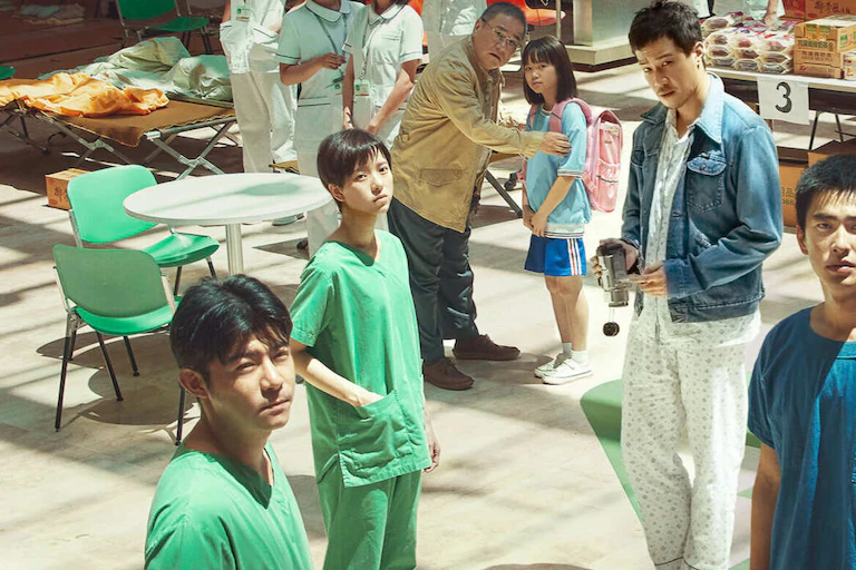Healthcare workers stand in a hospital canteen looking to camera.