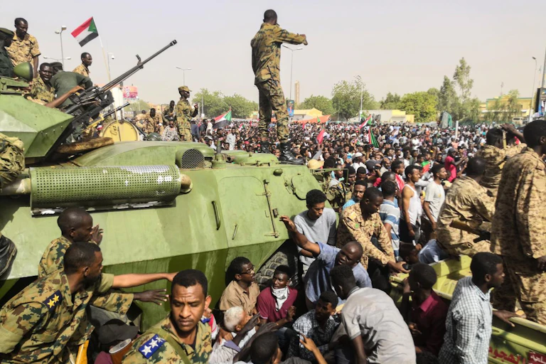 Soldiers and civilians walk in a street