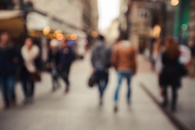 Blurred image of passers-by in a city.