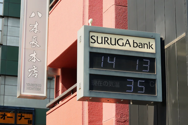 A bank exterior with a numerical display showing the time and temperature.
