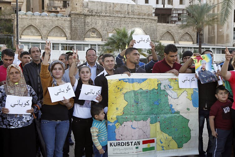 Kurdish protesters in Lebanon with a map of Kurdistan