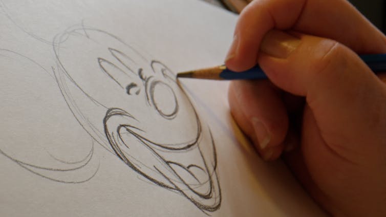A hand drawing Mickey Mouse's face