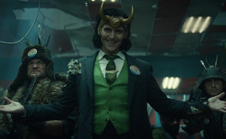 Loki in a green waistcoat and gold horns