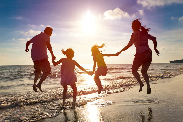 Family jumping on a beach.
