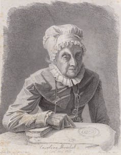 A black and white portrait of an older lady wearing a ruffled bonnet, pointing at a paper. She's holding a magnifying glass.