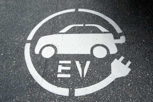 A street decal marking an EV charging zone.