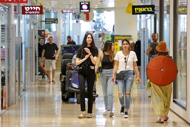 People walking in a shopping center.