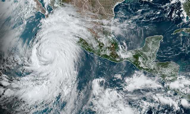 A satellite image shows a large hurricane off Mexico
