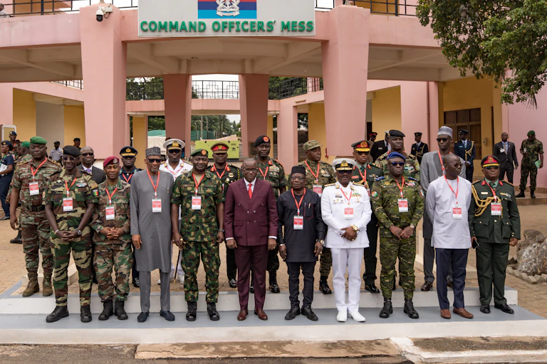 Unee quinzaine d'hommes en uniforme posent pour une photo de groupe