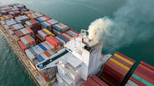 A container vessel emitting steam or white smoke.