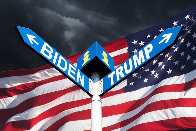 Signposts for Joe Biden to the left and DOnald Trump to the right with US flag in the background.