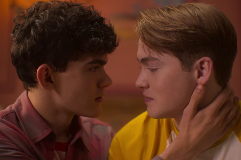 two teen boys about to kiss