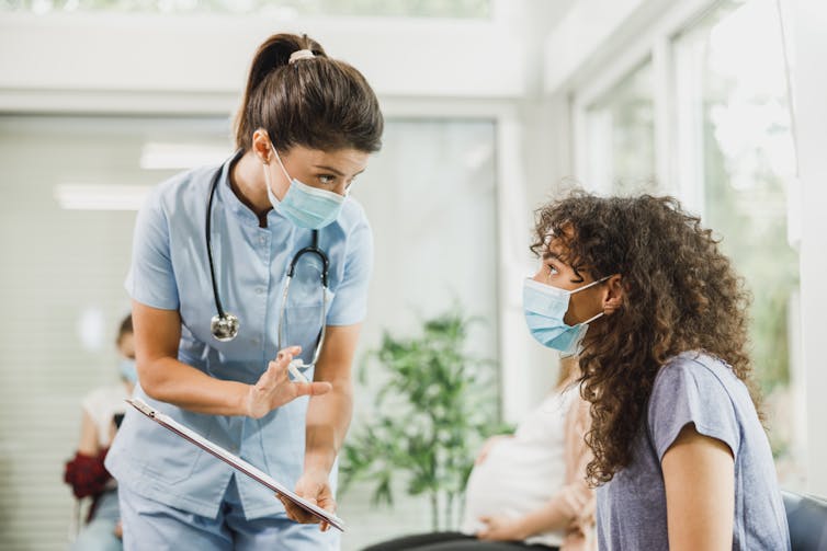 Teen talks to nurse in waiting room