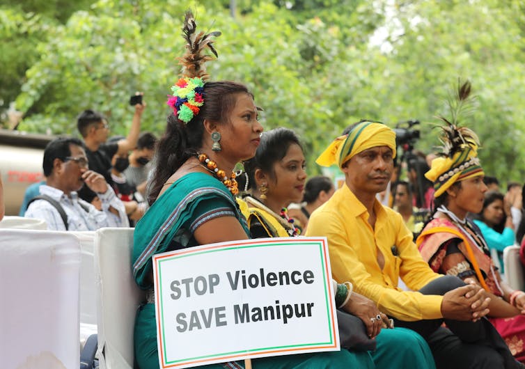 Protesters in India's Manipur state hold up placards demanding an end fo sexual violence against women.