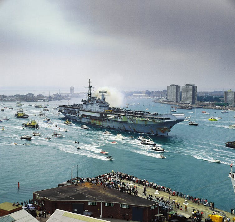 There was a ship anchored in the harbor, and there were many small boats nearby.
