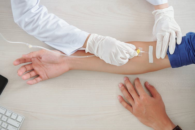 A patient’s arm being prepared for an infusion.