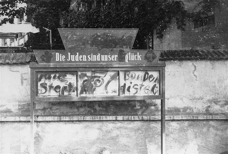A vintage photo of a box for displaying newspapers, with German writing on it.