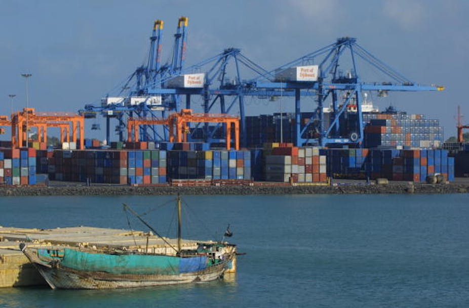 A photo of Djibouti port showing a small boat against a background of containers and cranes.