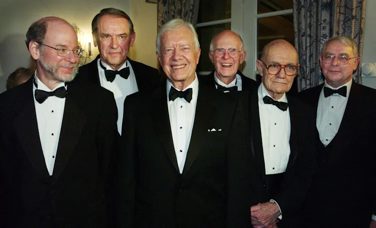Six men dressed in formal dinner jackets