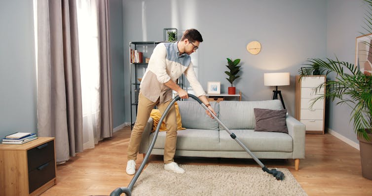 A man cleans an already tidy house.