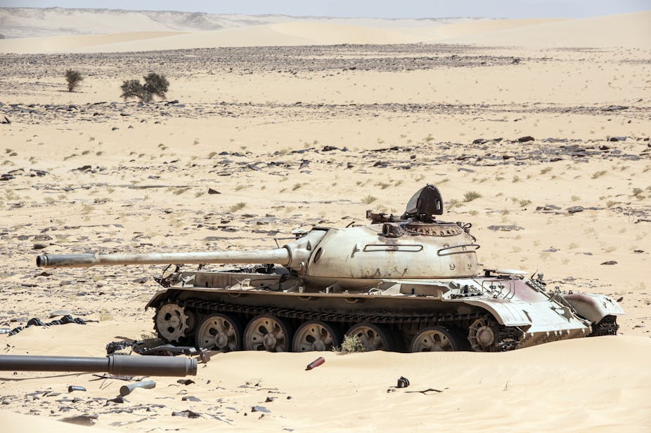 A destroyed military tank in the desert