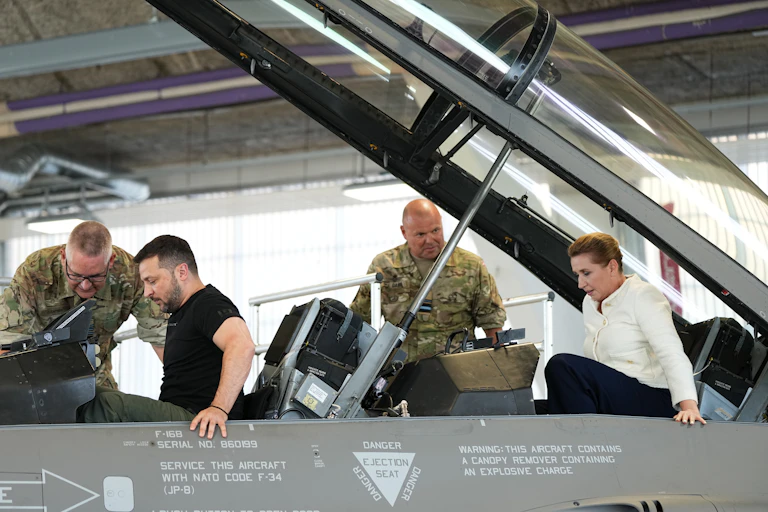 Ukrainian president, Volodymyr Zelensky, and Denmark's prime minister, Mette Frederiksen, climb into a F-16 fighter jet at Skrydstrup Airbase in Vojens, Denmark.