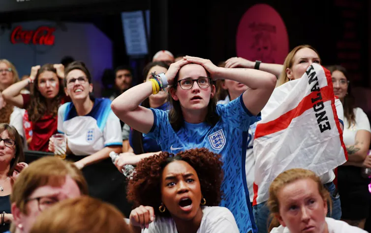 Worried England fans watch the World Cup final.