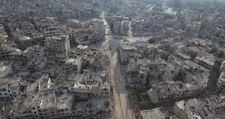 Aerial photo showing a city devastated by bombing.