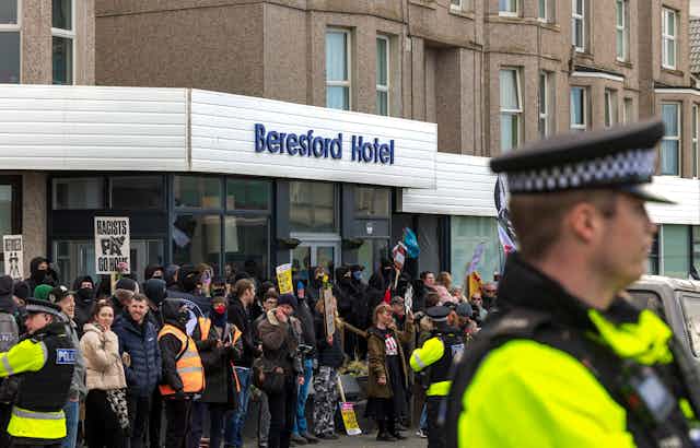 Protesters and police outside the front door of the Beresford hotel in Cornwall