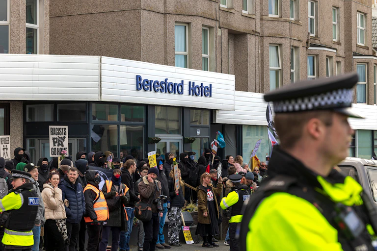 Protesters and police outside the front door of the Beresford hotel in Cornwall