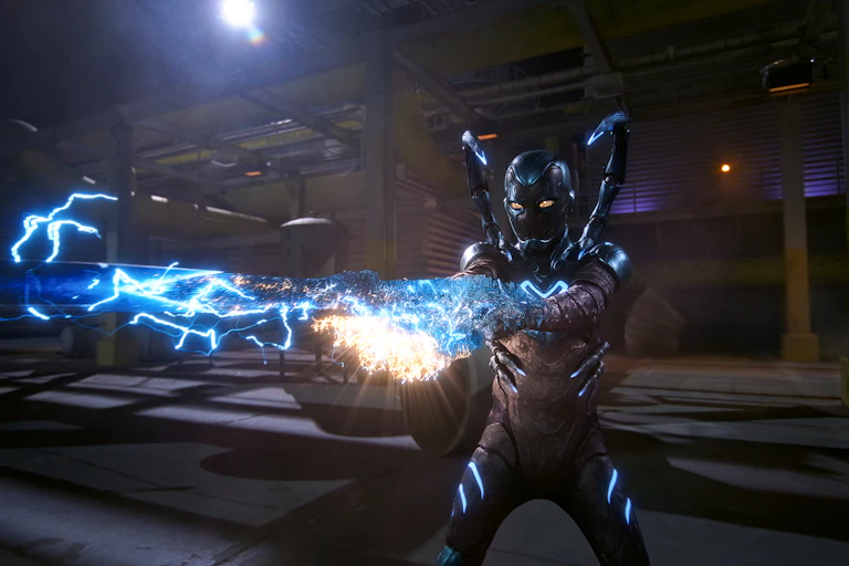 Blue Beetle in his blue suit sending out a blue electrical charge from his hands.