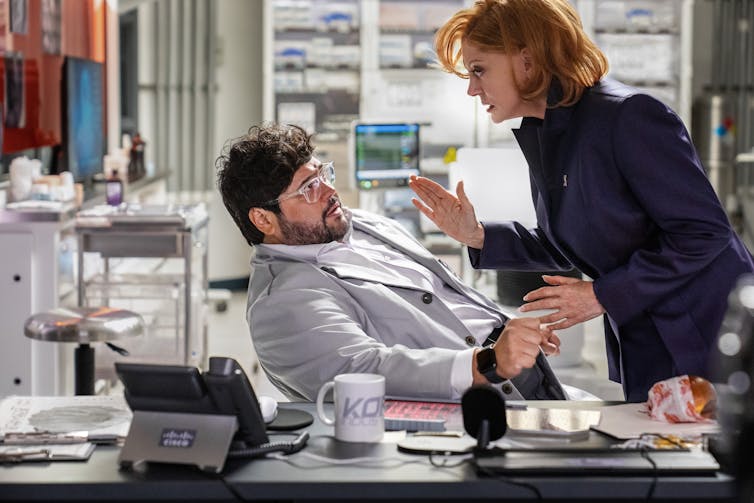 Dr. Sanchez cowers away from Victoria Lord.