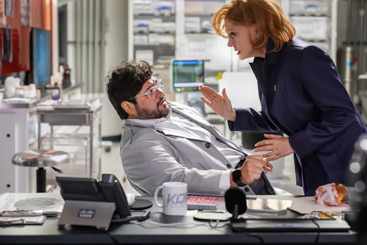 Dr. Sanchez cowers away from Victoria Lord.