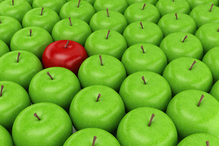 Group of green apples with one red apple.