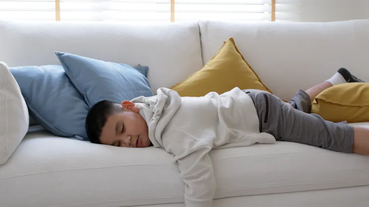 Boy asleep on couch
