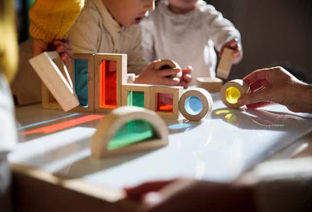 children play with blocks on table
