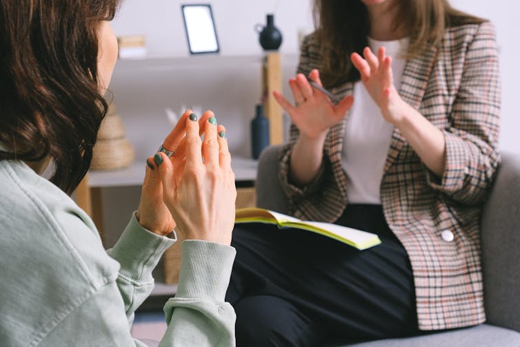 Two woman talking, one a client, one a therapist.