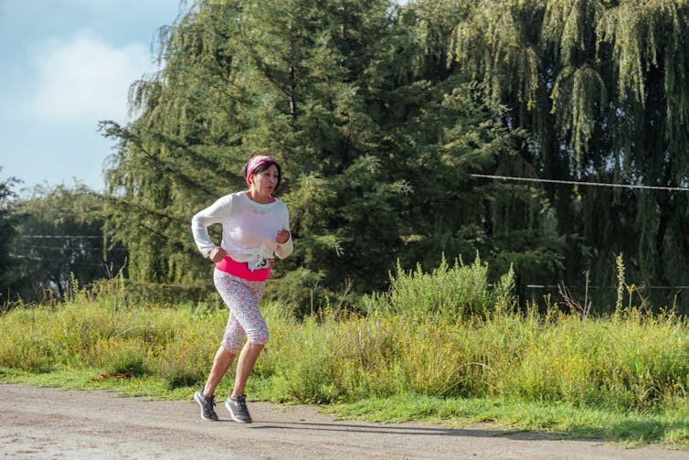 Woman running on country road.