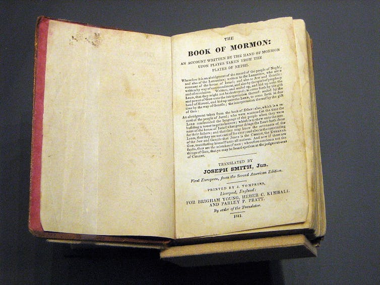 An old book open to the first page.