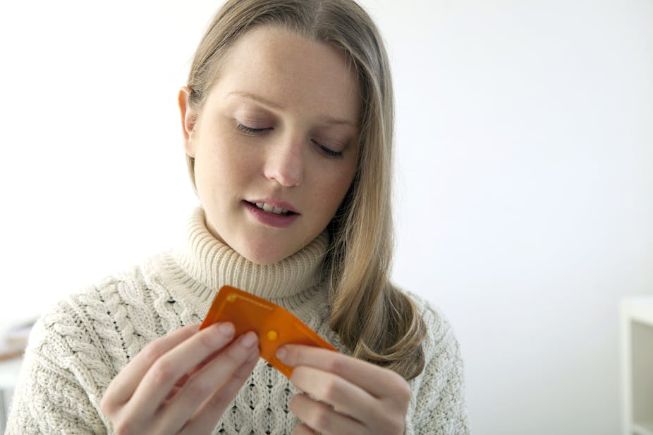 A woman holds a blister pack containing the morning after pill.