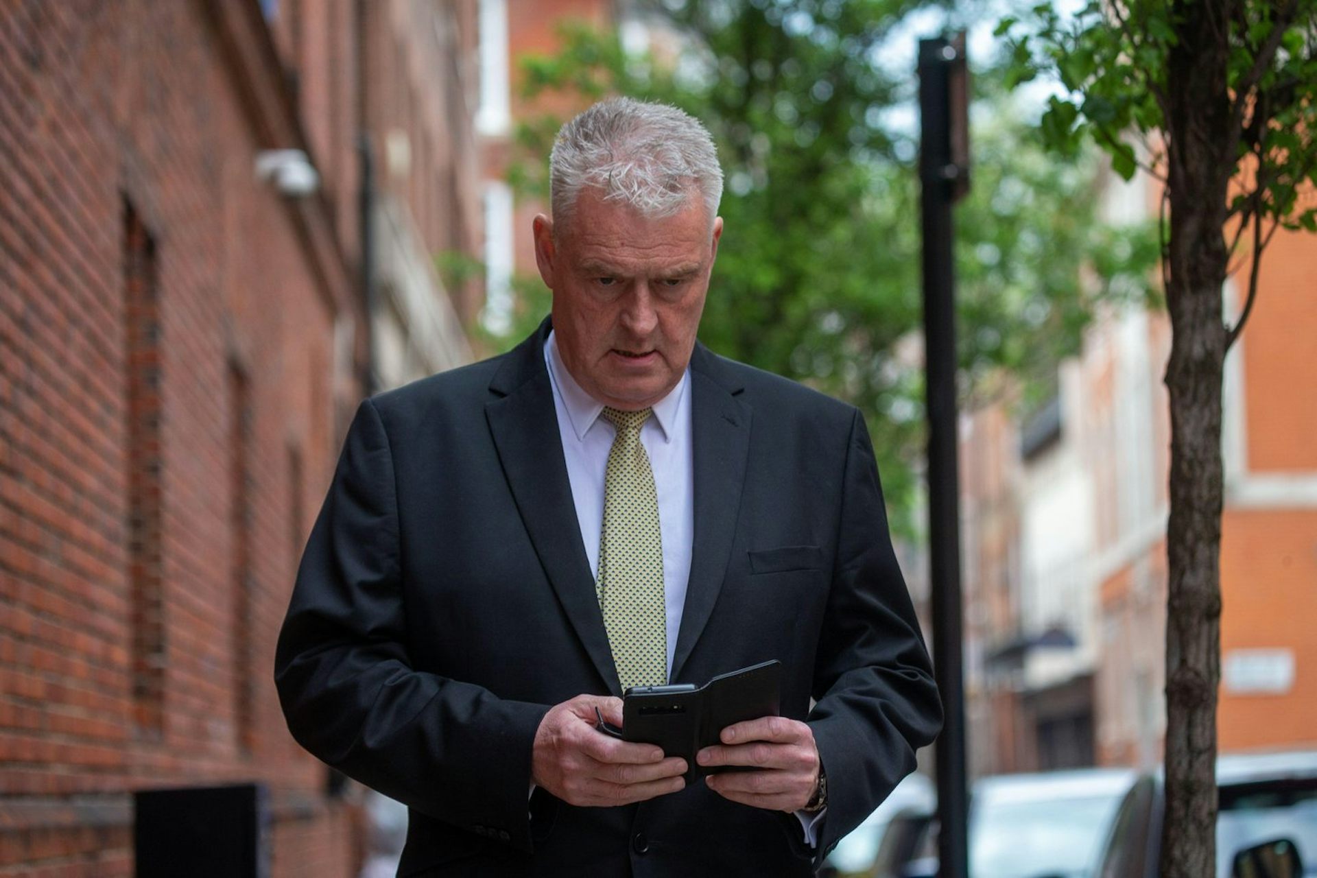 Lee Anderson looking at his phone