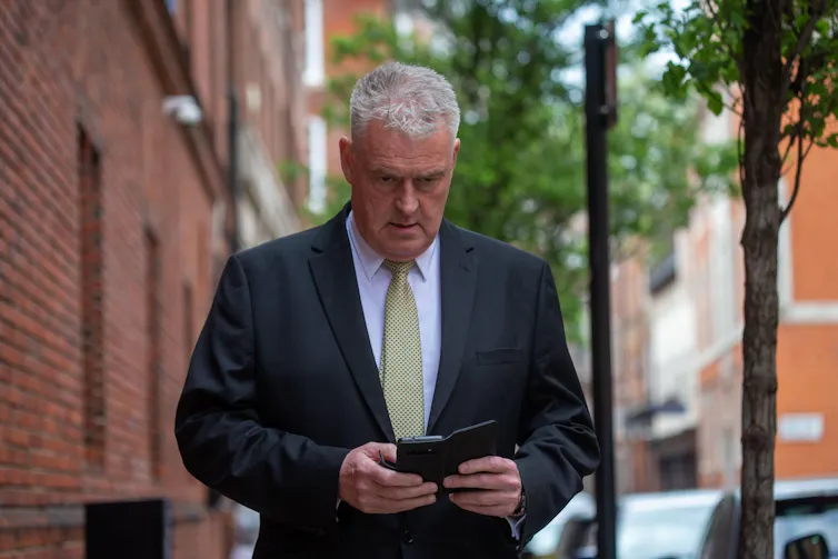 Lee Anderson looking at his phone