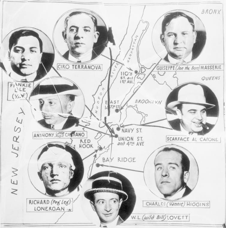 A black and white cartoon shows a map of New York City with photos of different known Mafia men, including Al Capone.