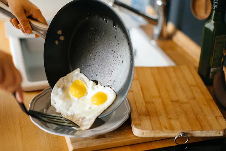 Two fried eggs in a frying pan.