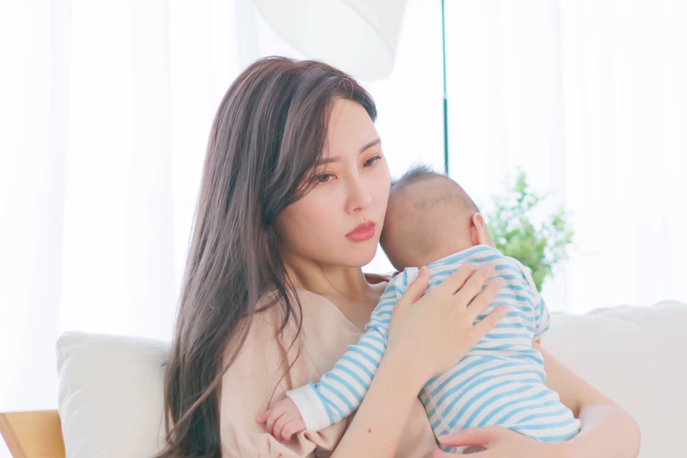 A woman holding an infant