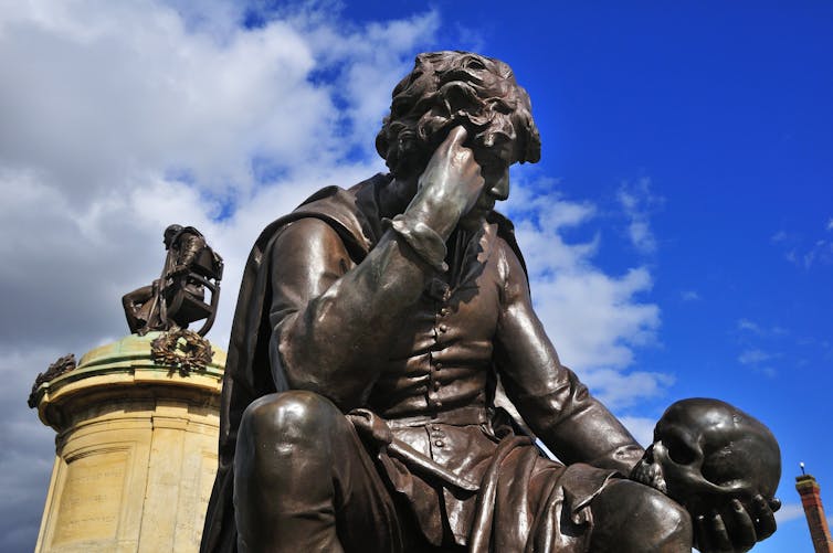 A statue of Hamlet with Yorrick's skull.