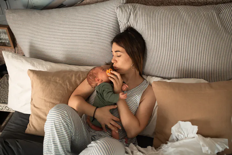 Woman in bed with baby.