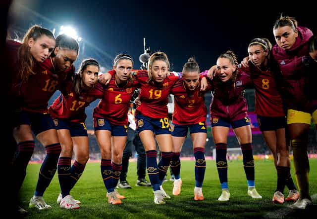 The Spanish women's team huddles on the pitch before a match