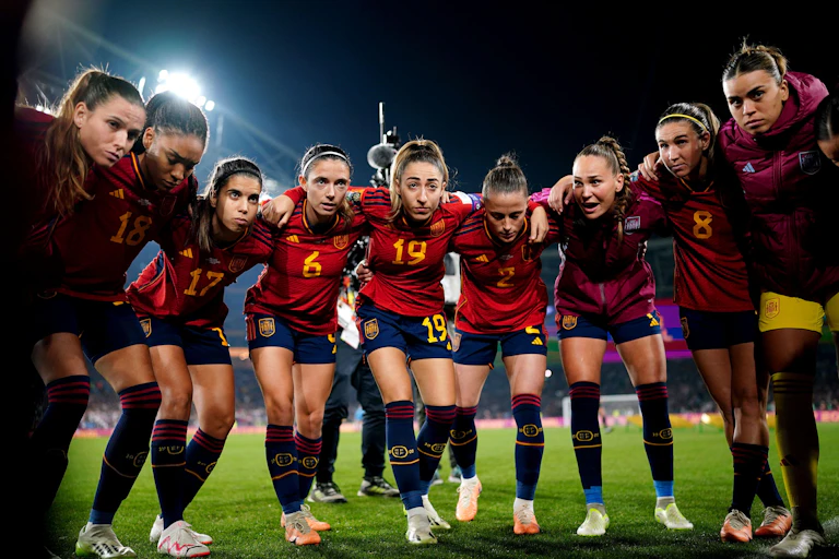 The Spanish women's team huddles on the pitch before a match