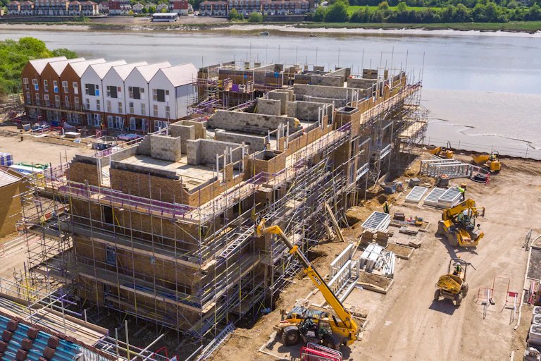 Aerial photo of homes being built near a river.
